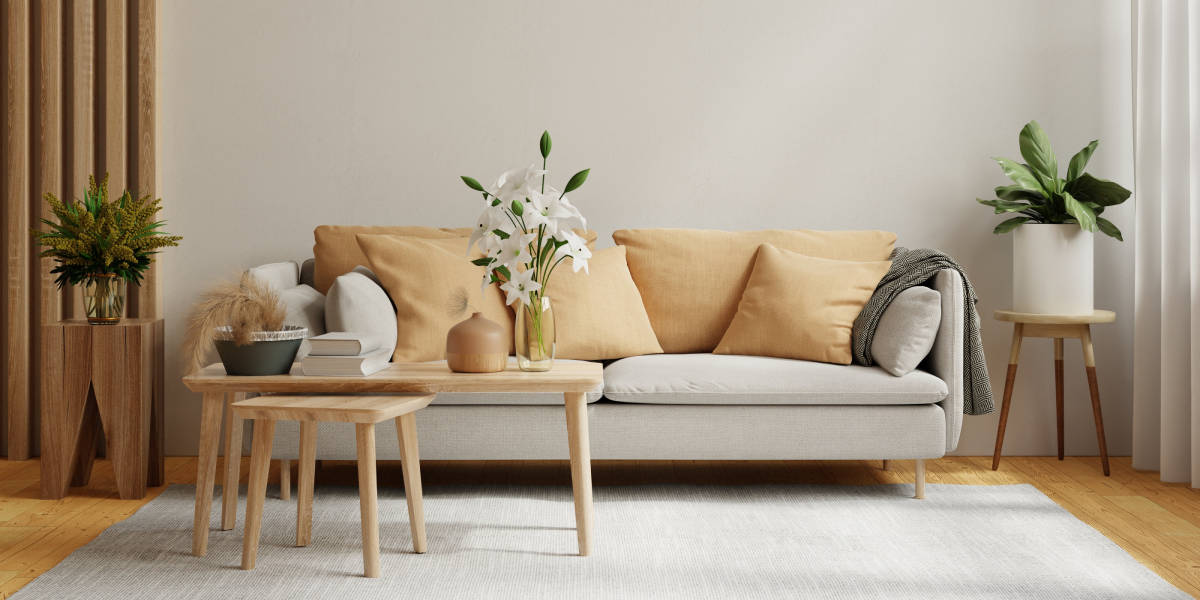 Grey sofa with yellow cushions and small wooden table
