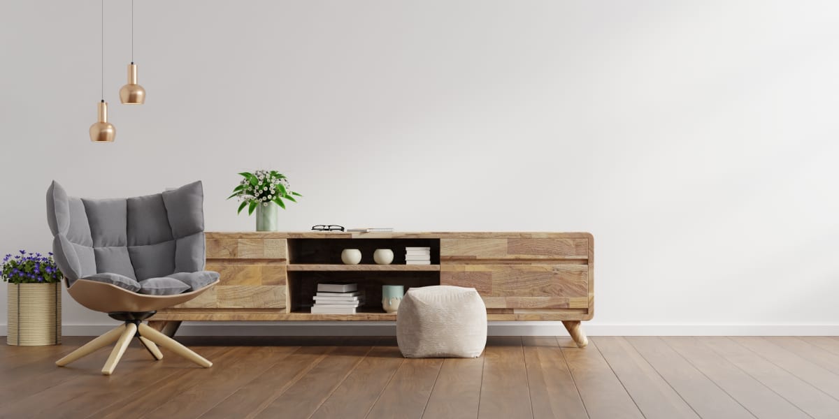 Grey chair with sideboard and plant