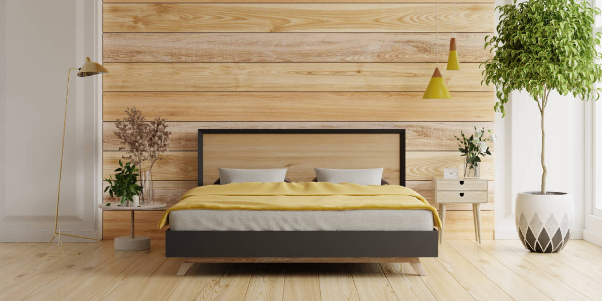 Bedroom with wooden panel walls and wooden floor