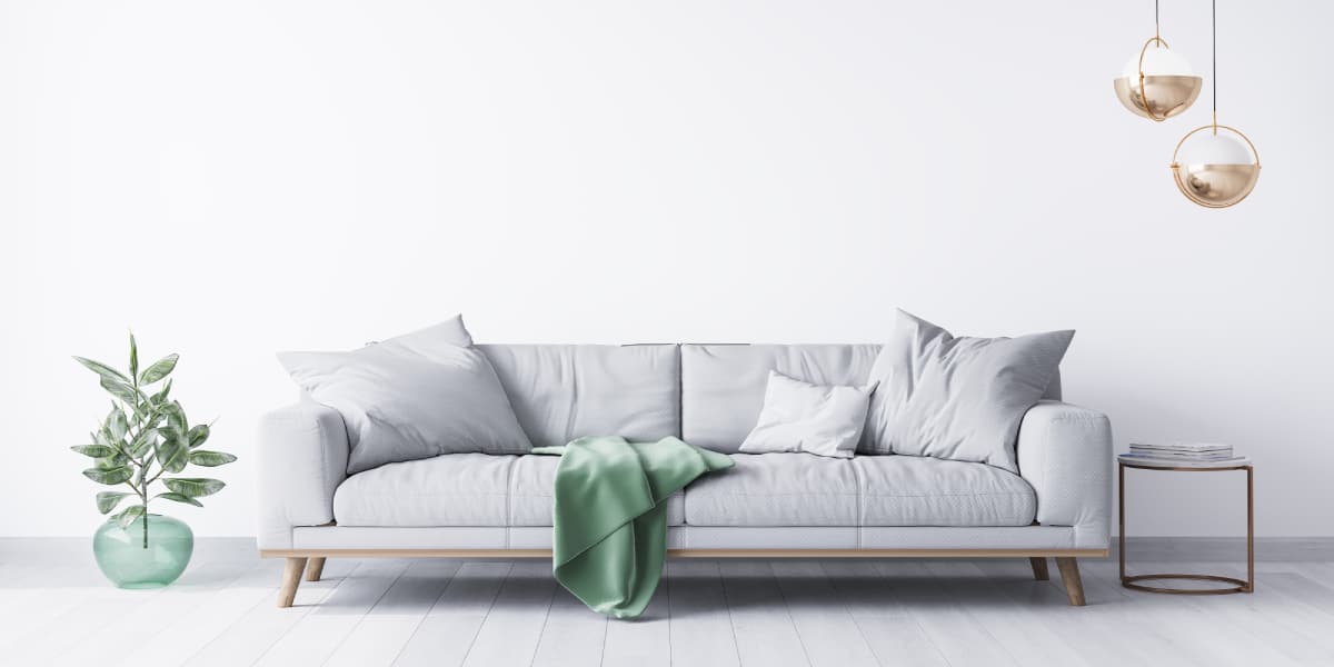 Grey sofa with green blanket
