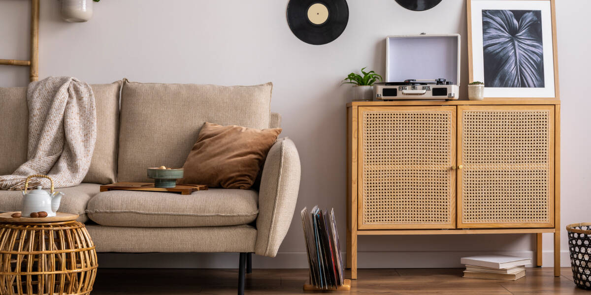 Beige sofa with sideboard and vinyl on wall