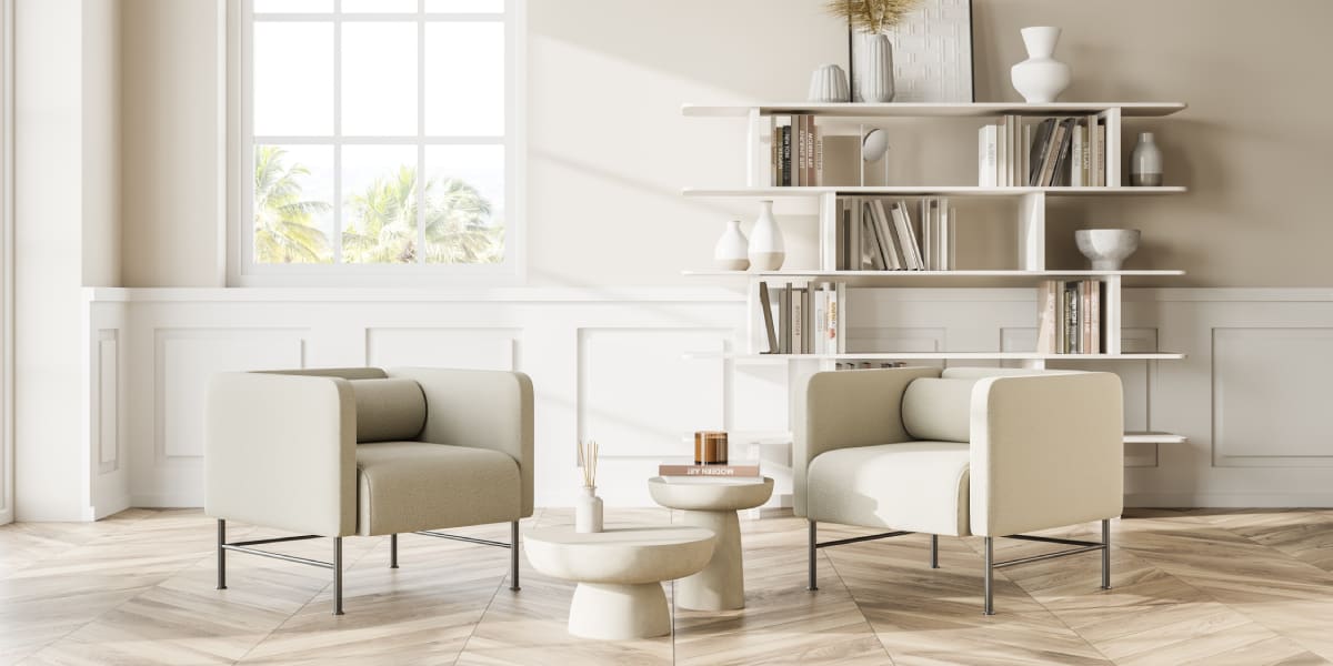 Beige sofa with light coloured walls and bookshelf