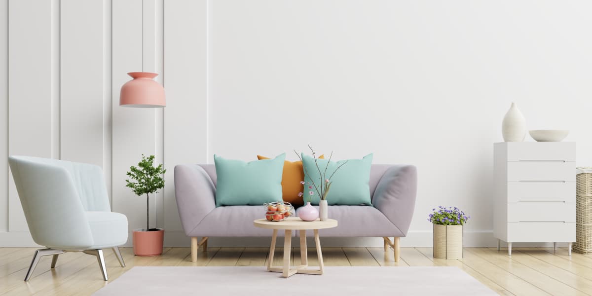 Purple pastel coloured sofa with green and orange cushions